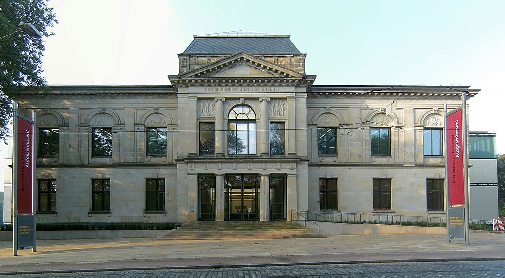 Bremen’s brown-bricked Kunsthalle building with big windows and sculptures over them