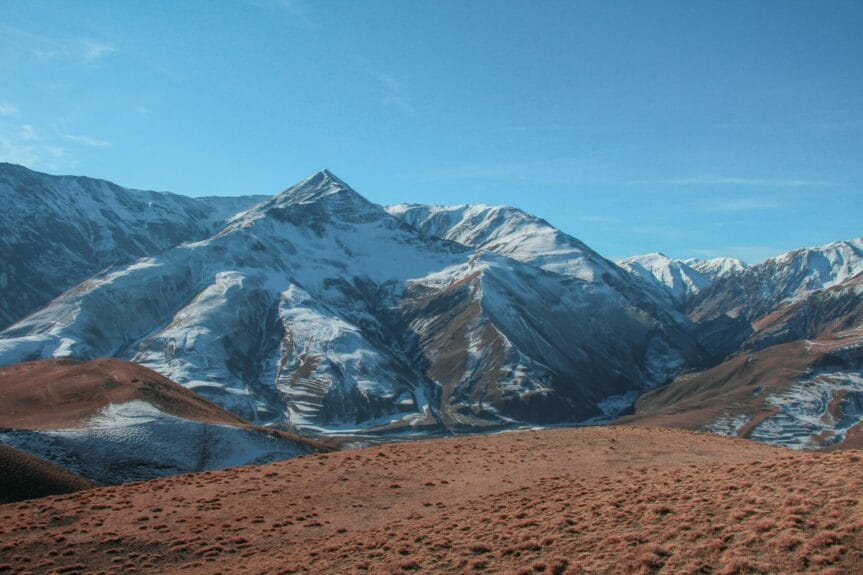 A view of a snow mountain range from the top of a hill in Khinalug, Azerbaijan.