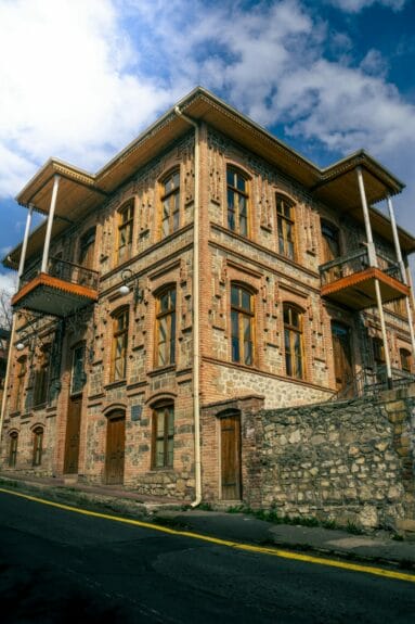 An old building made from bricks and stones along the roadside in Shaki, Azerbaijan.