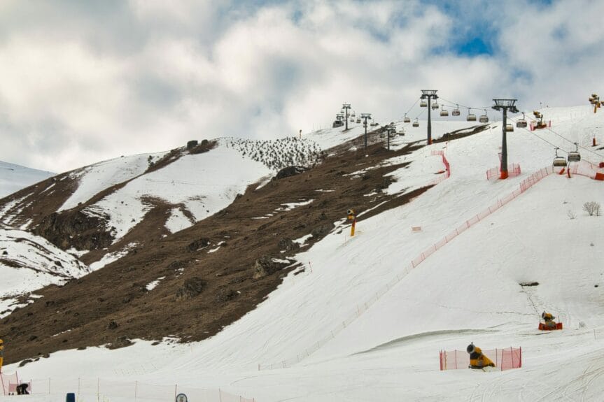 Ski lift on a foggy and snowy mountain with a snow cannon in Shahdag, Azerbaijan.