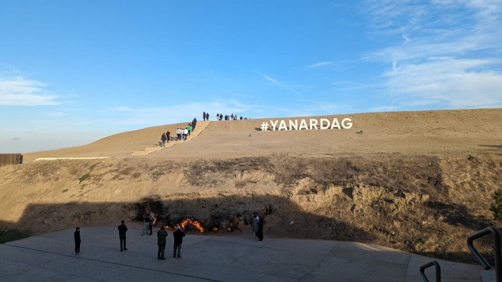 People watching a fire blaze continuously on the hillside of Baku, Azerbaijan. 