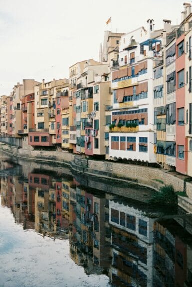 Tall colorful buildings right on the river banks in Girona.