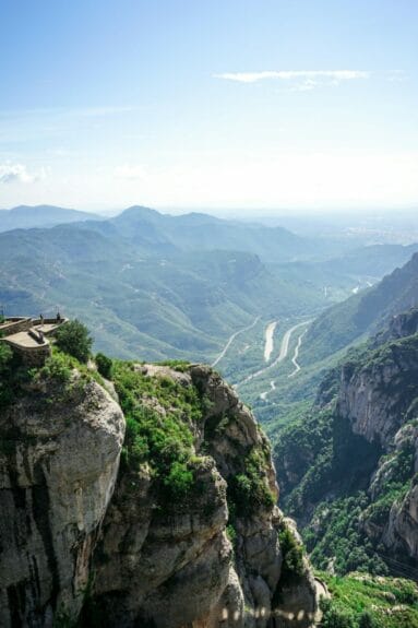 The green-covered mountain range and valleys of Montserrat on a sunny day.