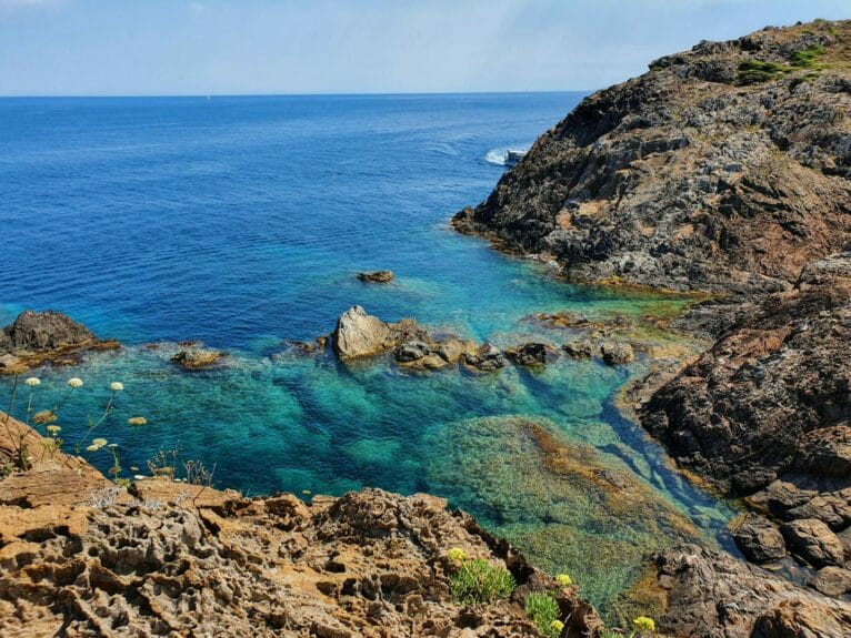 Rock formations in Cap de Creus through the clear water on a sunny day.