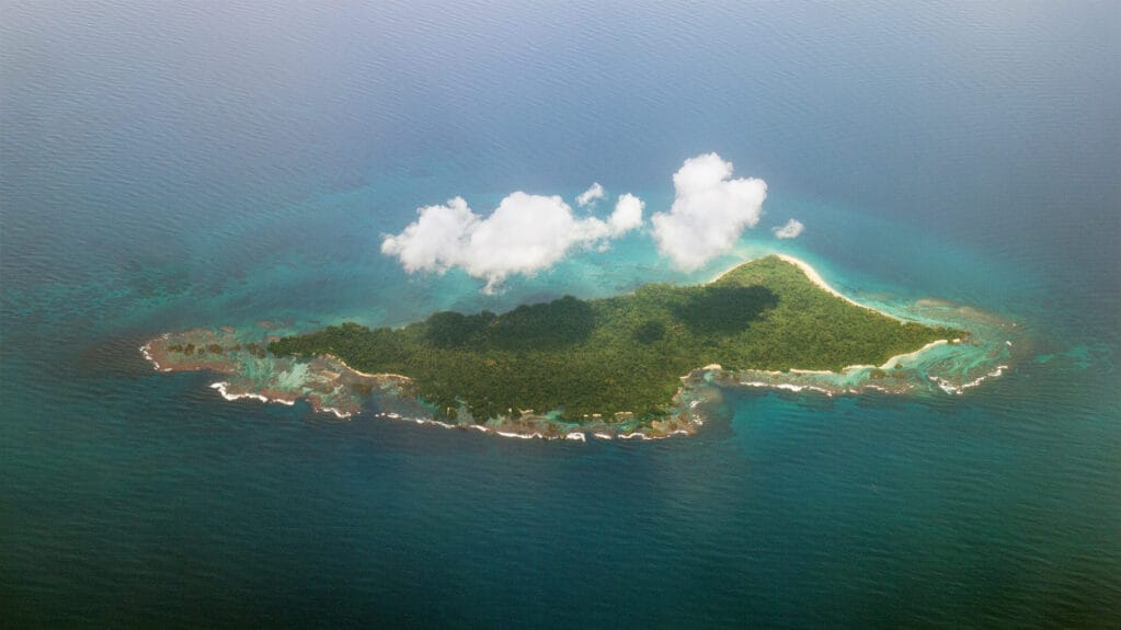 Aerial view of Isla Escudo de Veraguas with clouds on top of it in Panama.