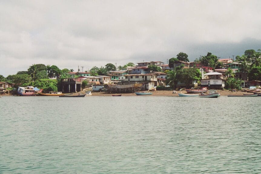 Boats and houses near the shore in Isla del Rey, Panama.