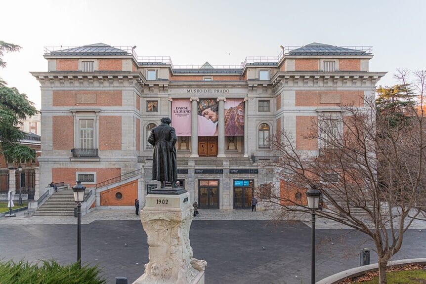 View of the north entrance of Museo del Prado in Madrid, Spain, with the monument in front.