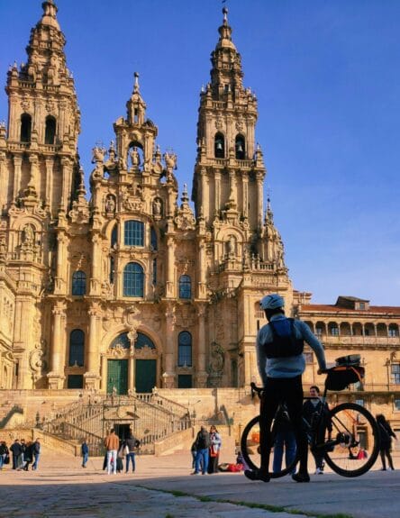 A group of people standing in front of Santiago de Compostela in Spain.